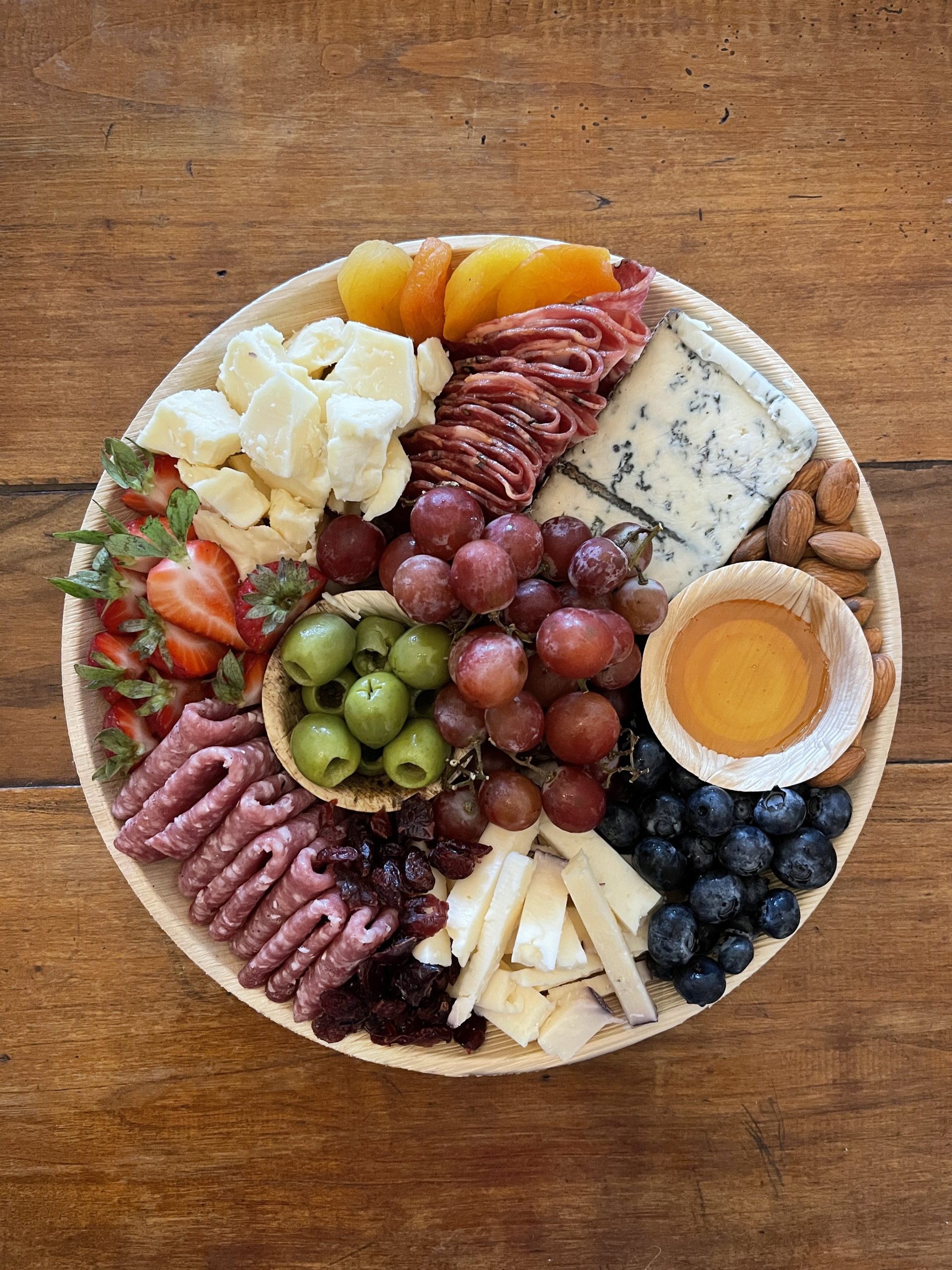A Martha's Vineyard Cheesery small grazing board, full of cheese, charcuterie, and accompaniments