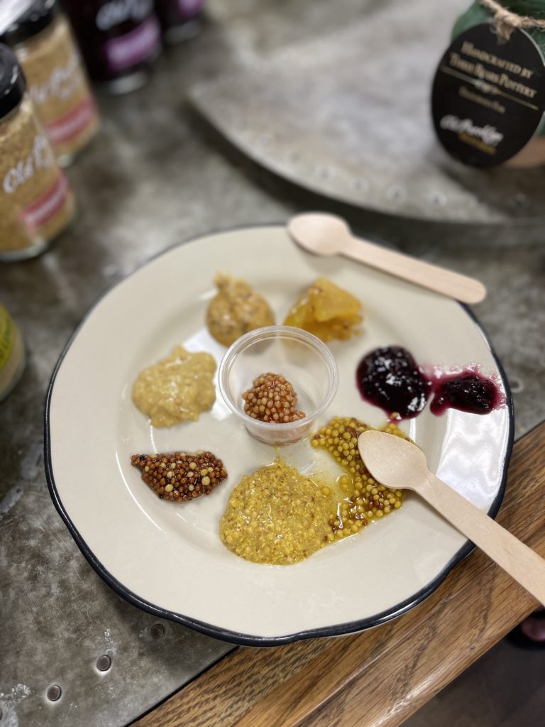 A mustard sampling plate from Old Brooklyn Cheese Co.