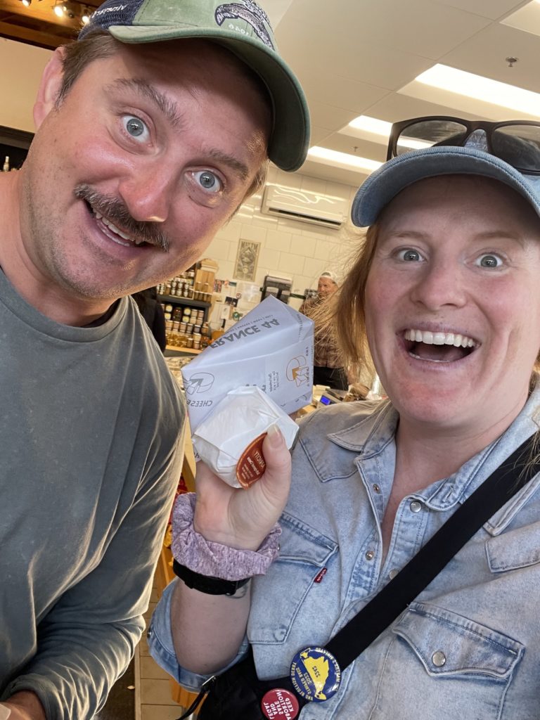 Morgen and Alex happily display their purchases from Coffin cheese case at France44 cheese shop in Minneapolis, Minnesota