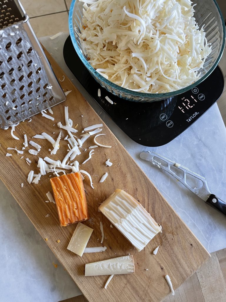 Process photo of shredding the cheeses for mac & cheese