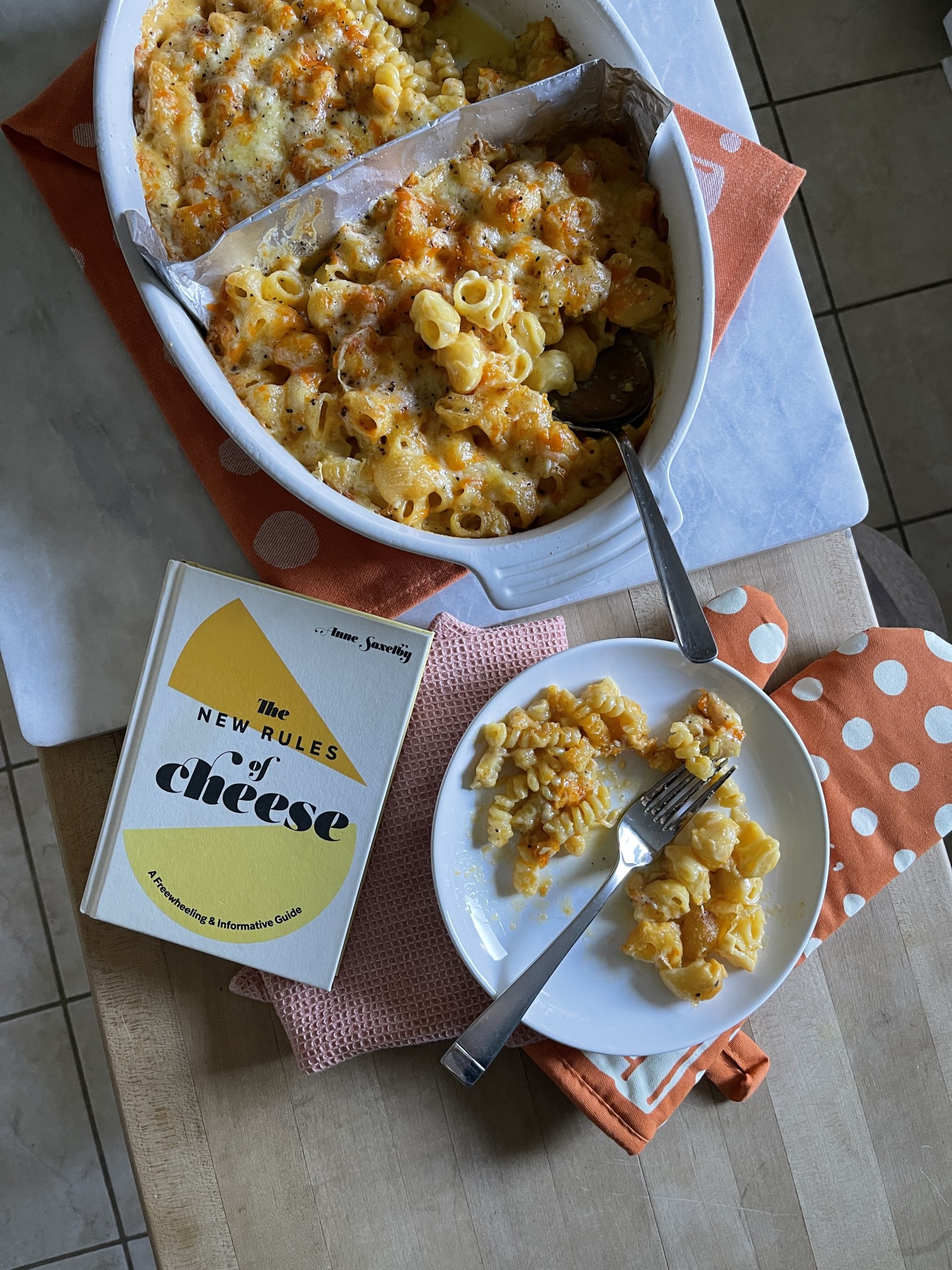 Overhead shot of the completed dish and the book that inspired it, The New Rules of Cheese