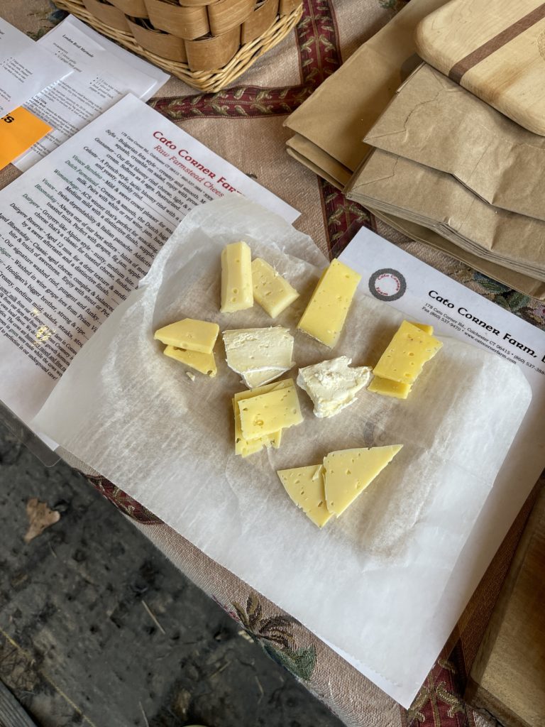 A cheese tasting plate with 8 different types of Cato Corner Farm cheeses.