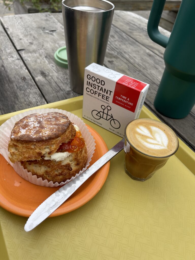 A cortado and a biscuit with cream cheese and hot pepper jelly from Tandem